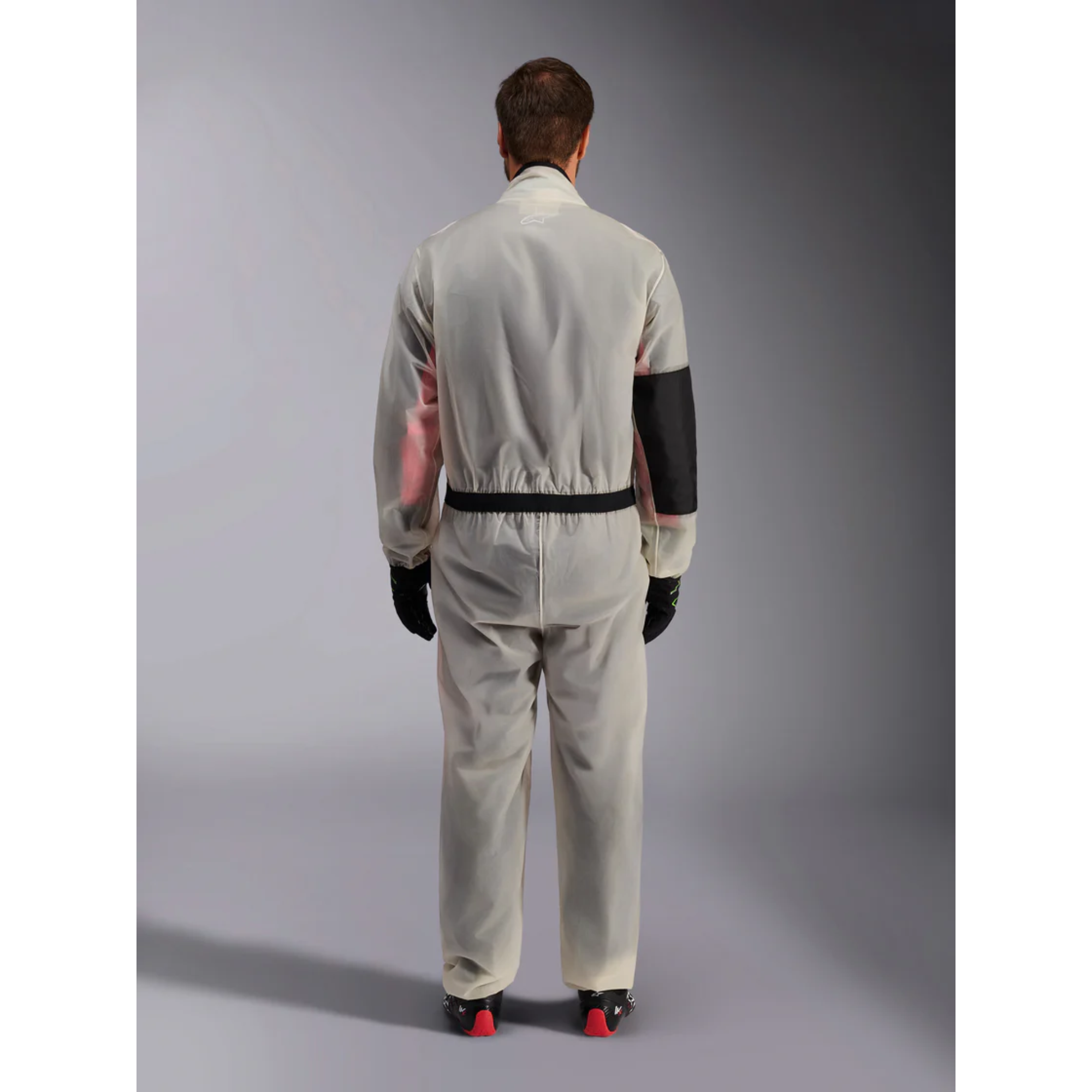 The Alpinestars Kart Rain Suit on a model from the back.