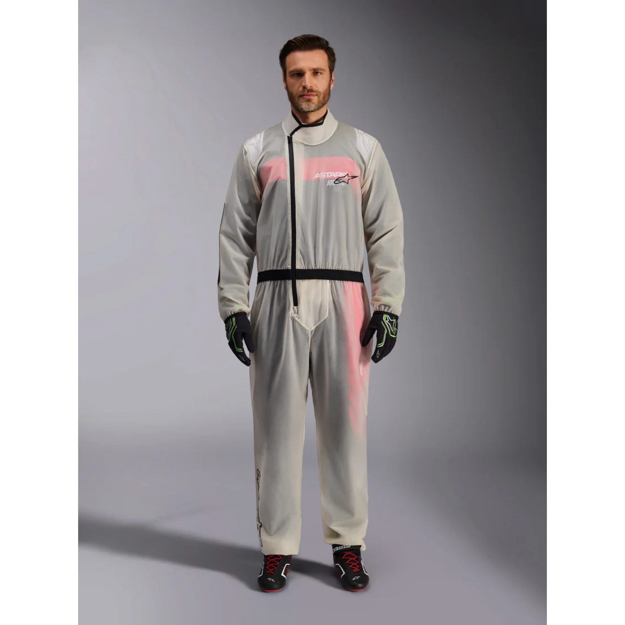 The Alpinestars Kart Rain Suit on a model standing.