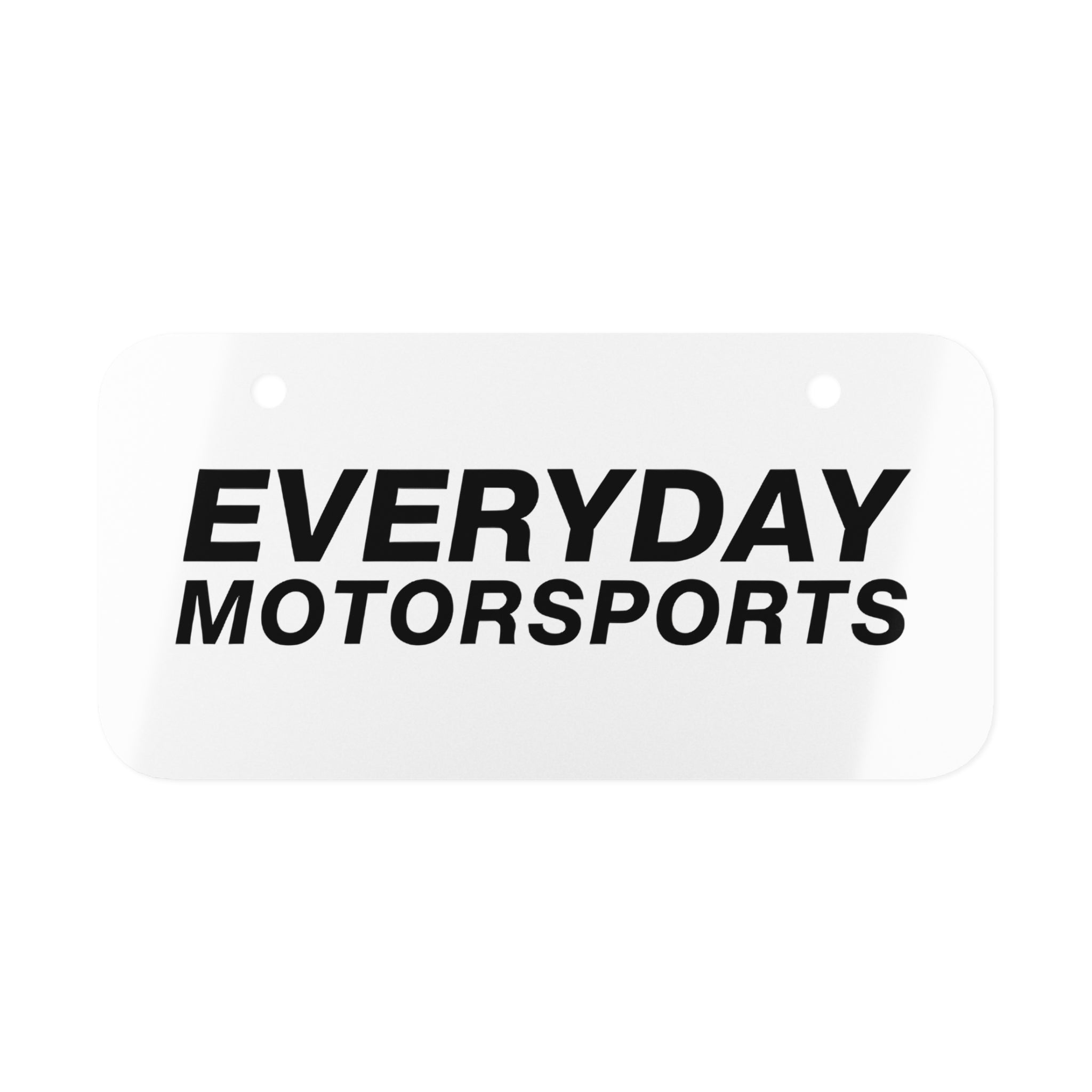 A white mini license plate with the black Everyday Motorsports logo on it. The Everyday Motorsports Mini License Plate.