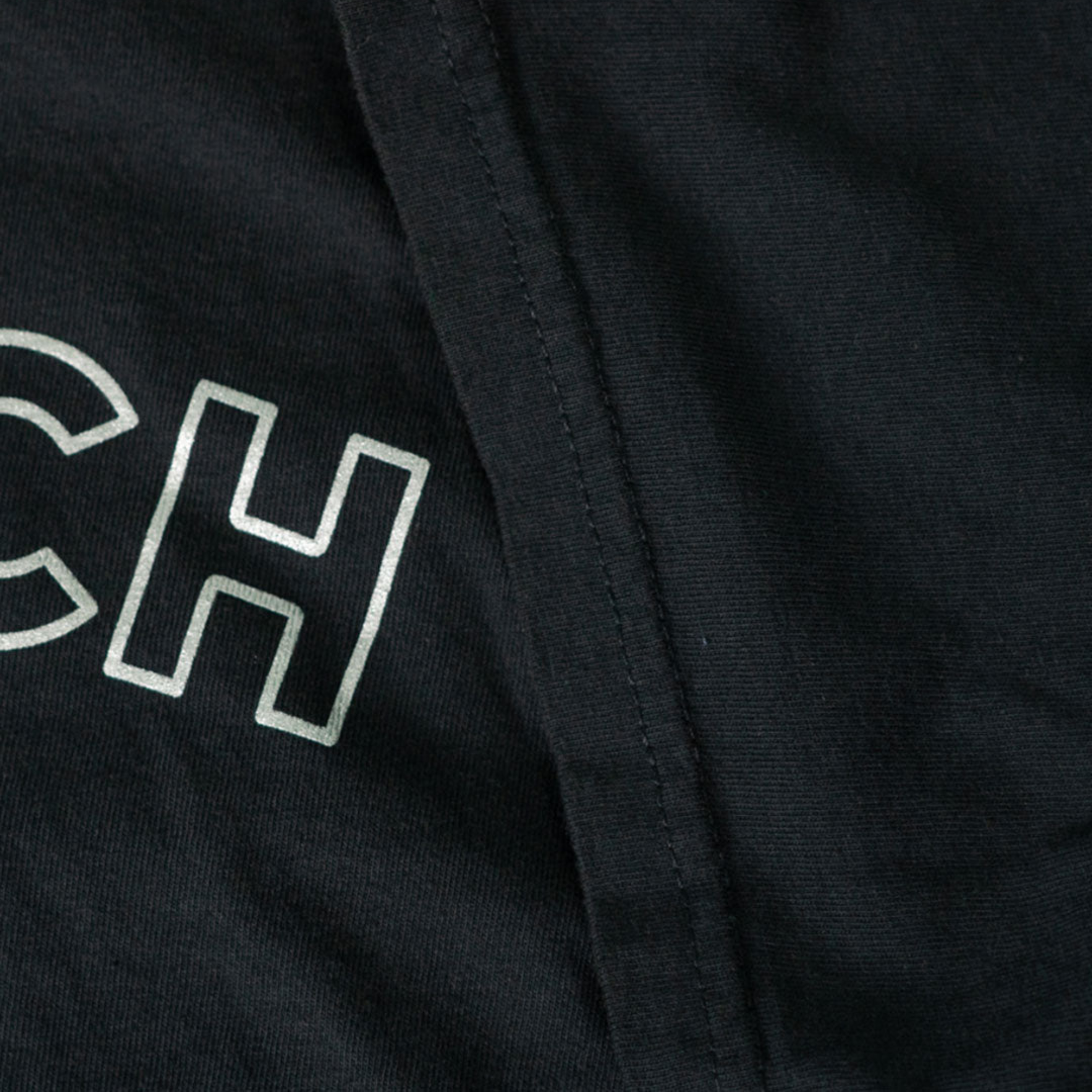 The black Car Rich Cash Poor Tee from Not Famous Racing Apparel showing the threading quality of the shirt.