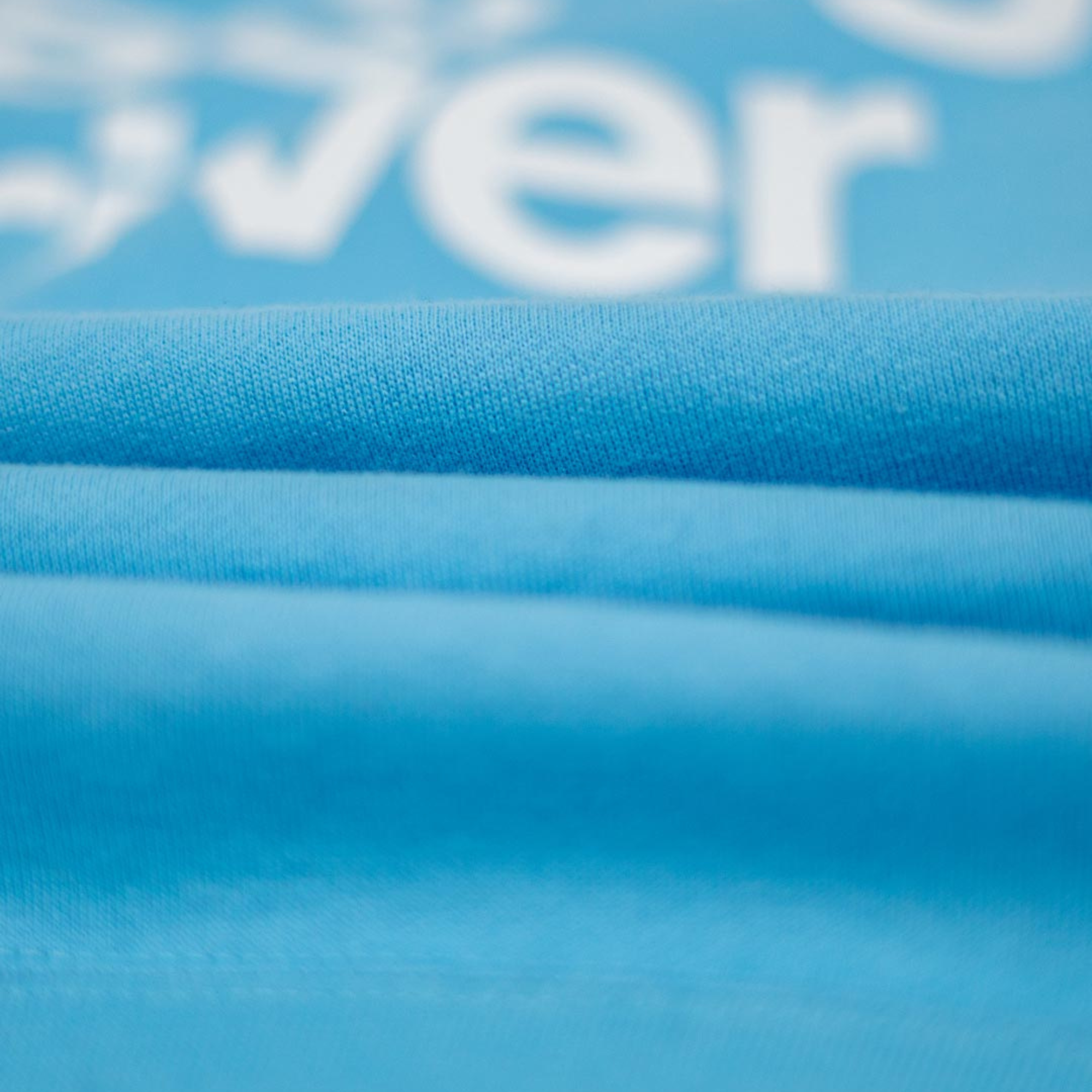 The fabric of the light blue Not Famous Racing Driver Hoodie from Not Famous Racing Apparel close up.
