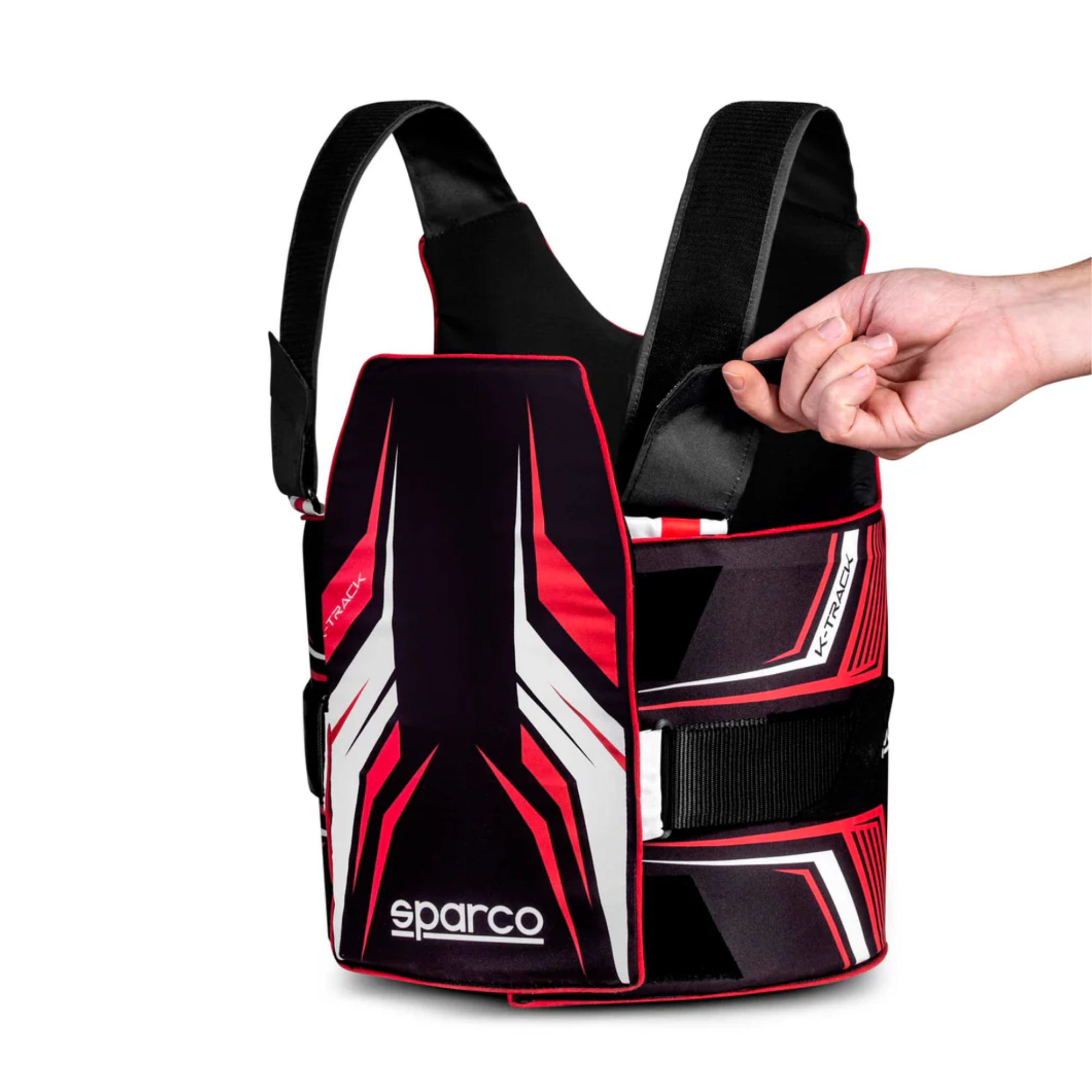 The black and red Sparco K-Track Rib Protector Vest from Sparco pulling the strap the adjust the protective gear.