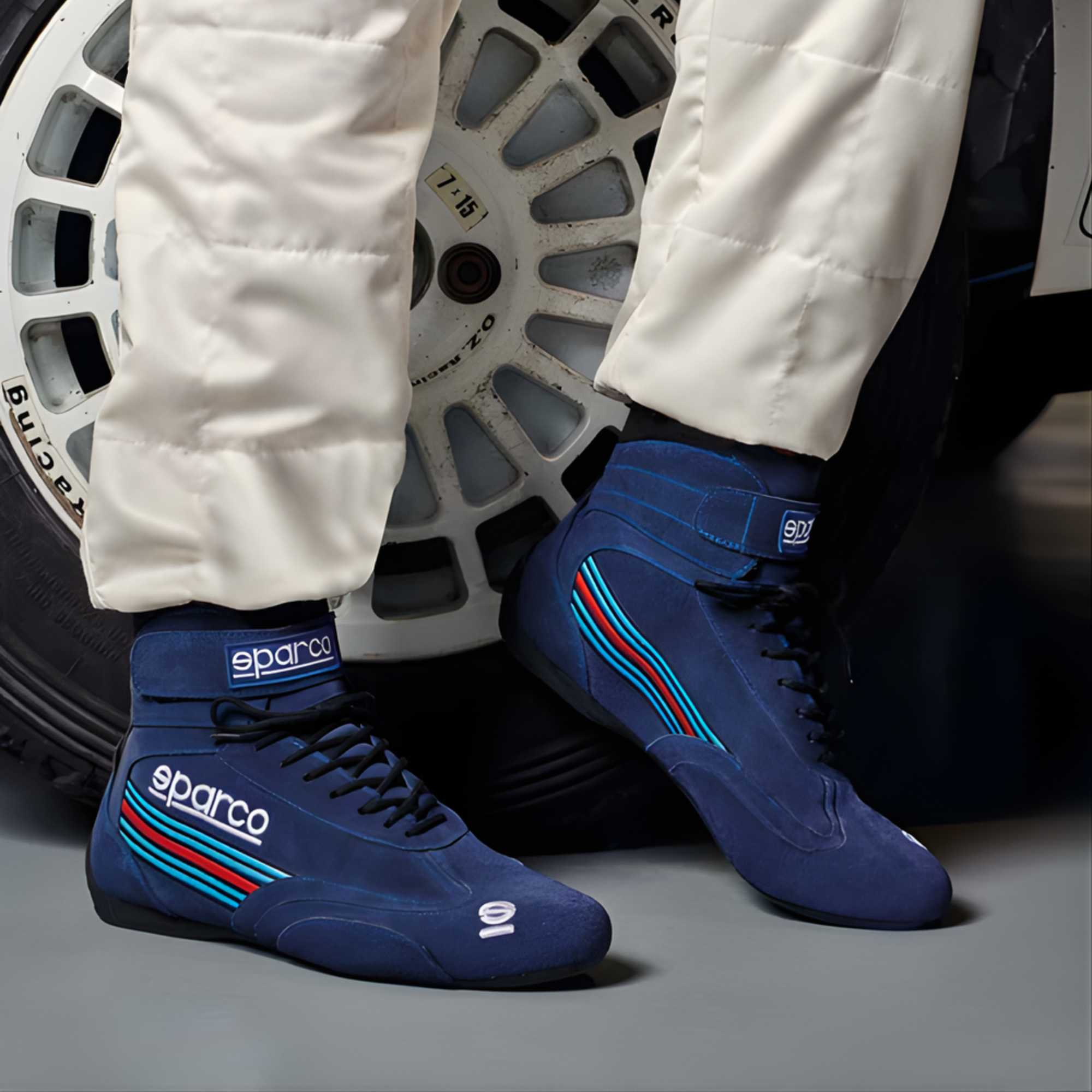 The navy Sparco Martini Top Racing Shoes worn by a driver in a car paddock. all-groups