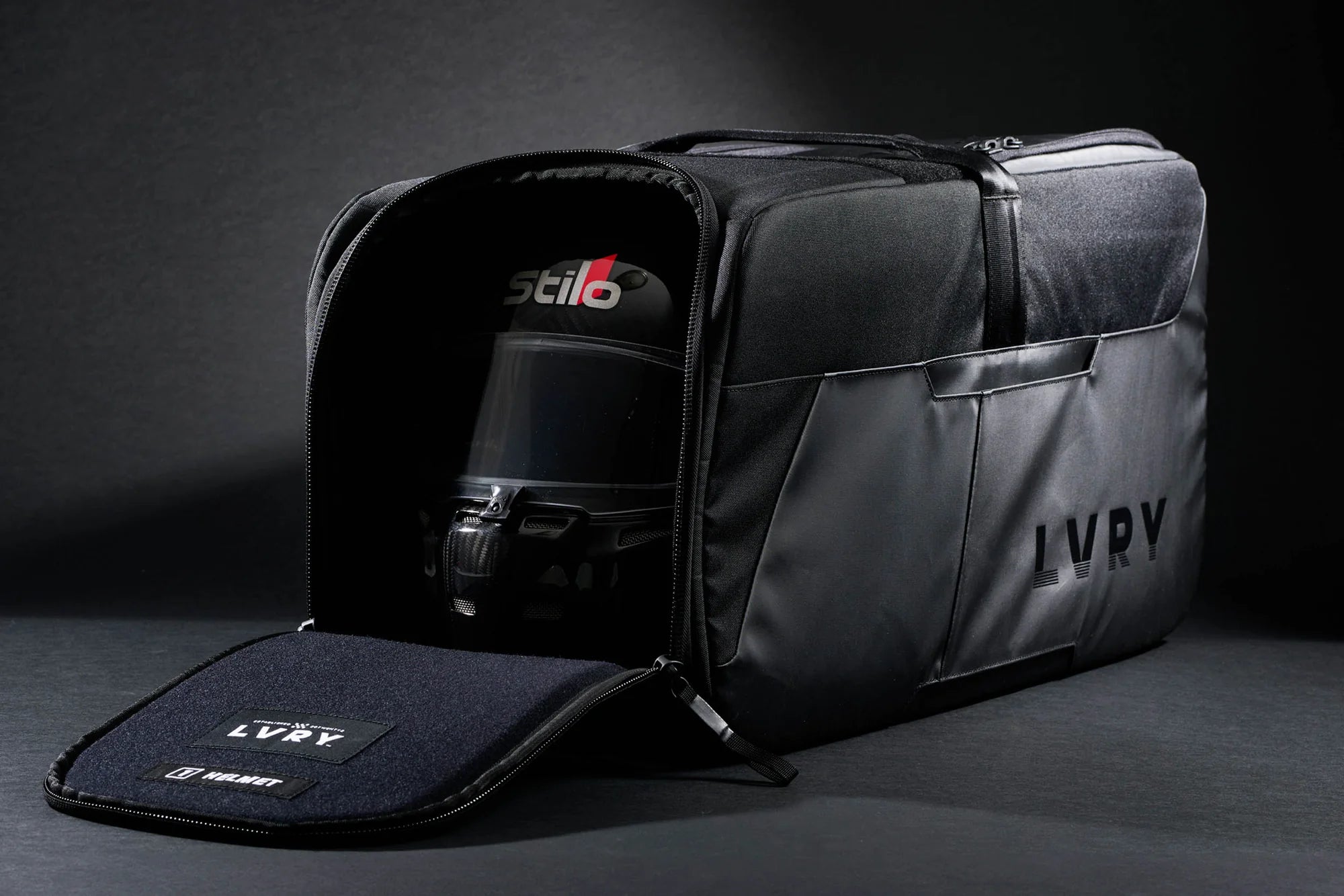 The LVRY CRRY Gear Bag from LVRY with a racing helmet.