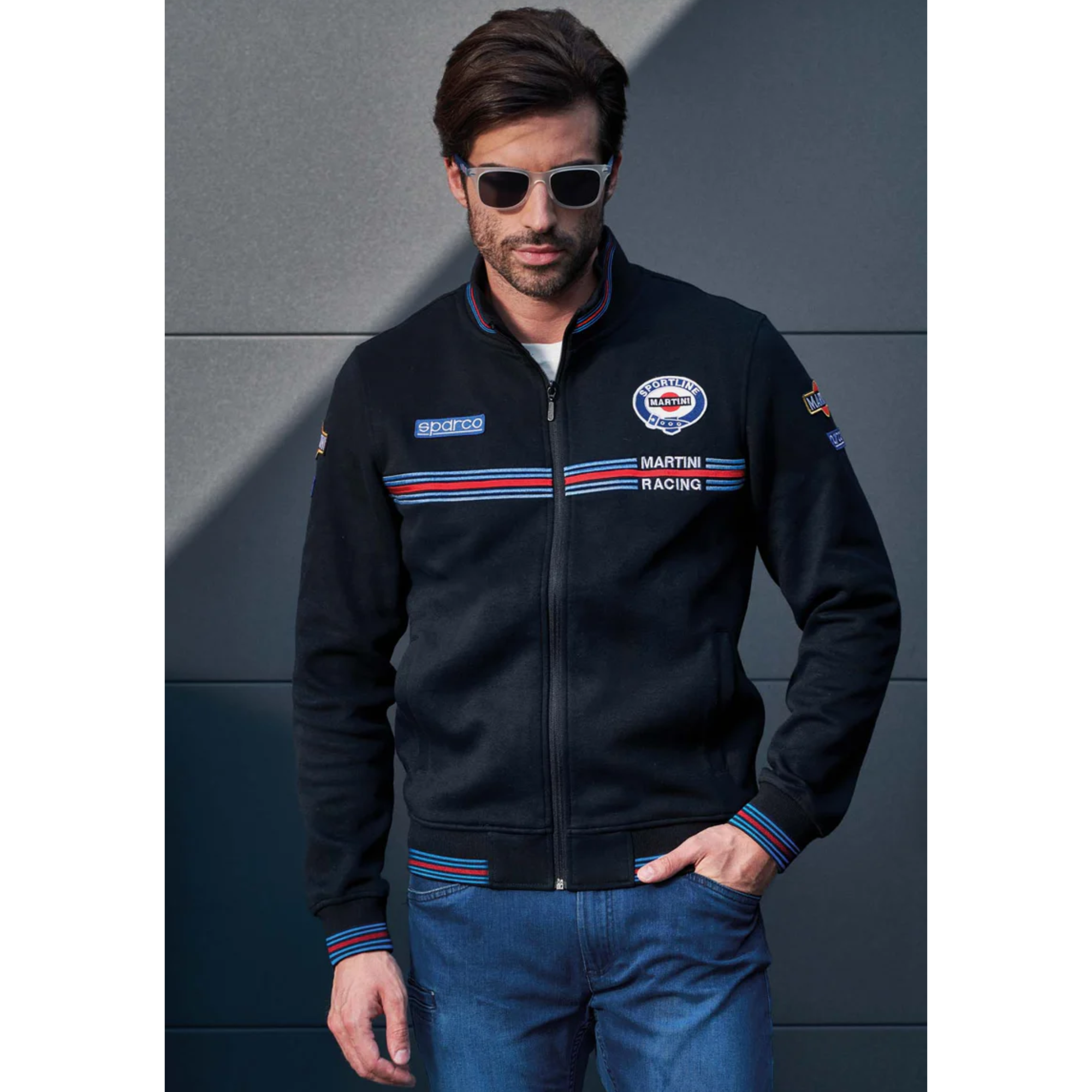 The black Sparco Martini Full Zip Sweatshirt from Sparco outdoors in a lifestyle photograph.