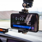 The APEX Pro Motorsport Phone Mount with a phone mounted on a car windshield.
