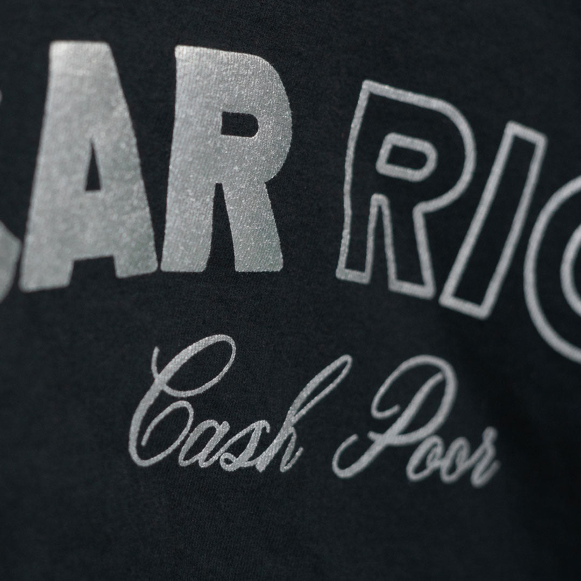 The black Car Rich Cash Poor Tee from Not Famous Racing Apparel showing the design close up.
