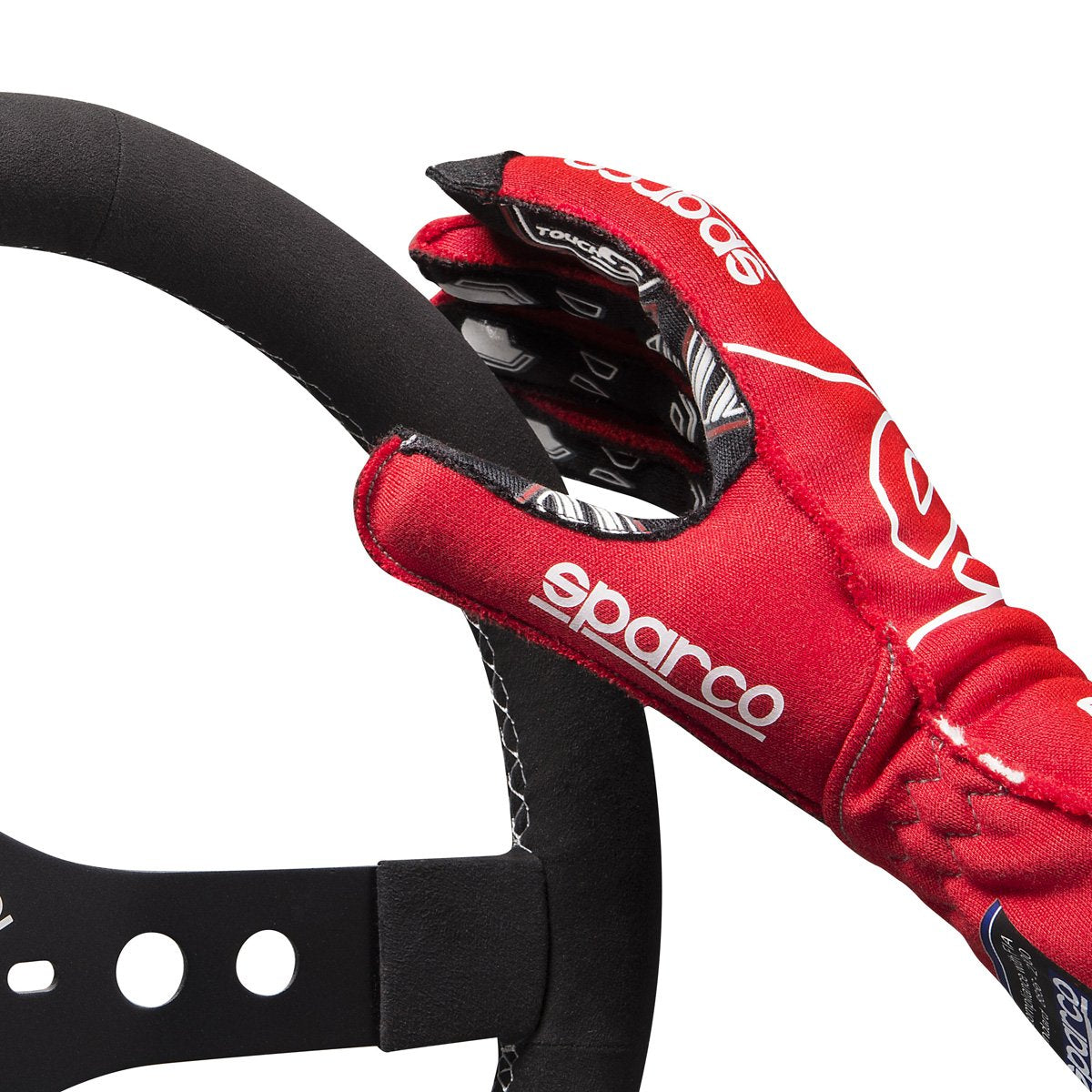 The red Sparco Arrow RG-7 Evo Racing Gloves gripping a steering wheel.