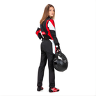 The black, red, and white Sparco Competition Women's Racing Suit from Sparco worn by a female racer model.