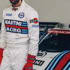 The Sparco Martini Racing Competition Racing Suit worn by a driver in the paddock.