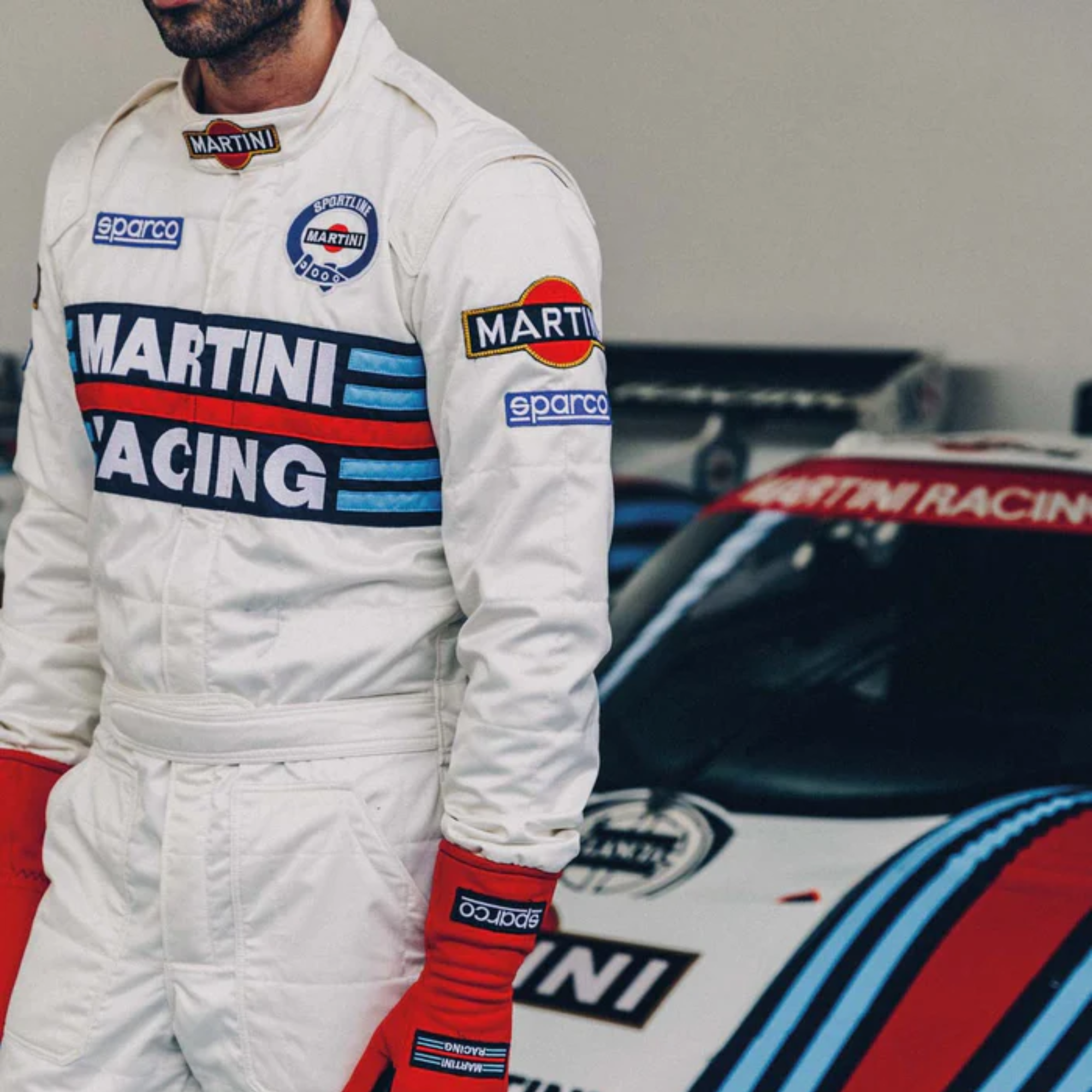 The Sparco Martini Racing Competition Racing Suit worn by a driver in the paddock.