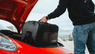 The LVRY CRRY Gear Bag from LVRY going into the trunk of red Porsche.