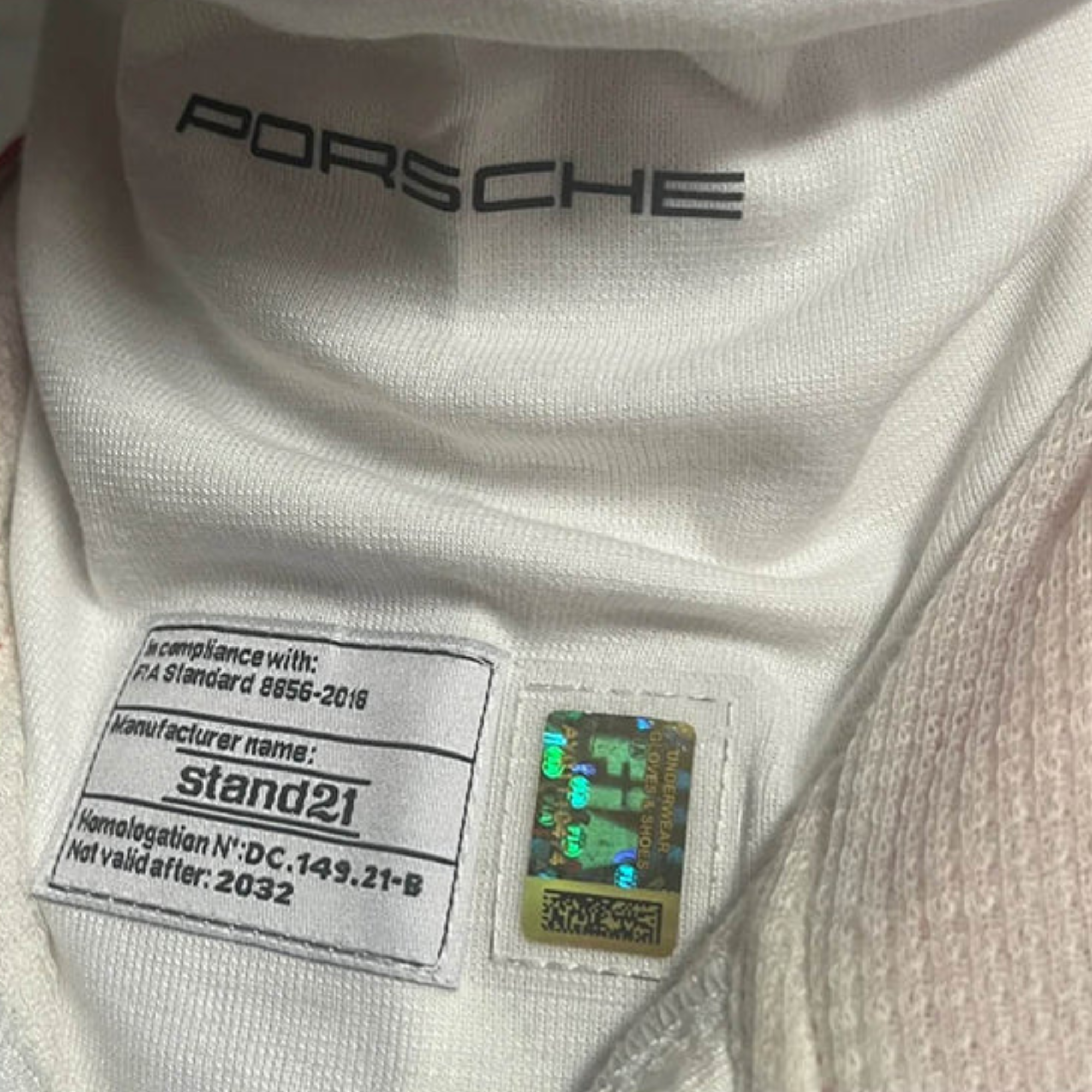 The Stand-21 Porsche Motorsports Balaclava from Stand 21 close up on the neck showing the FIA certification.